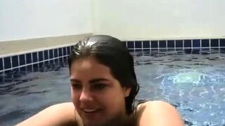 Beautiful girl shows her charms in the pool